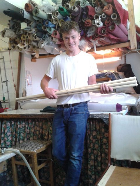 Ellis Mace in the workshop on Stockwell Street/Cowley Rd, Oxford holding our finished props for the Garden Dance (Sept 2018 #gardendance). Ellis works at - W.S.Cooke Upholsters who repair and restore furniture, as well as finishing these 1.2 meter wooden poles with which to we'll dance. Thank-you! (Photo 2018-08-31 13.09.22)