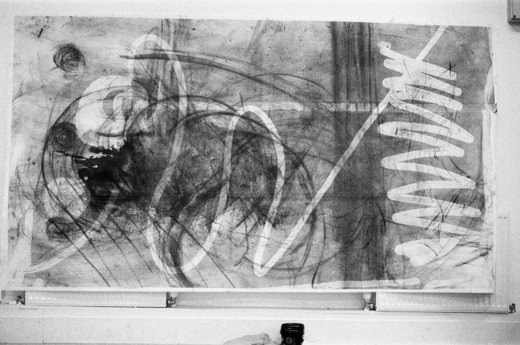 Residuals #1 image 002. Artists Andrew Wood & John Hazel. Charcoal on paper. Created 16 January 2024 at Old Fire Station dance studio, Oxford. UK. Photo: Andrew Wood. Black & whtie 35mm film photograph.