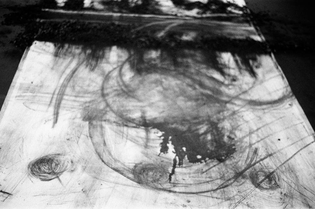 Residuals #1 image 0023. Artists Andrew Wood & John Hazel. Charcoal on paper. Created 16 January 2024 at Old Fire Station dance studio, Oxford. UK. Photo: Andrew Wood. Black & white 35mm film photograph.