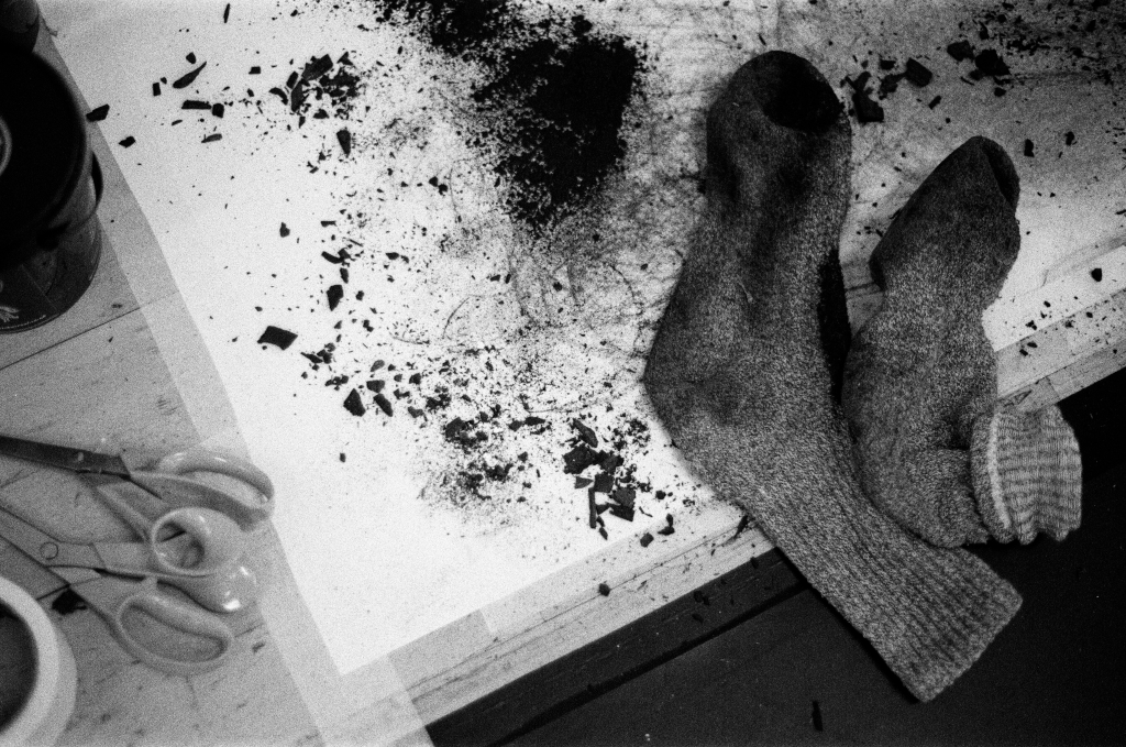 Residuals #1 image 0030. Artists Andrew Wood & John Hazel. Charcoal on paper. Created 16 January 2024 at Old Fire Station dance studio, Oxford. UK. Photo: Andrew Wood. Black & white 35mm film photograph.