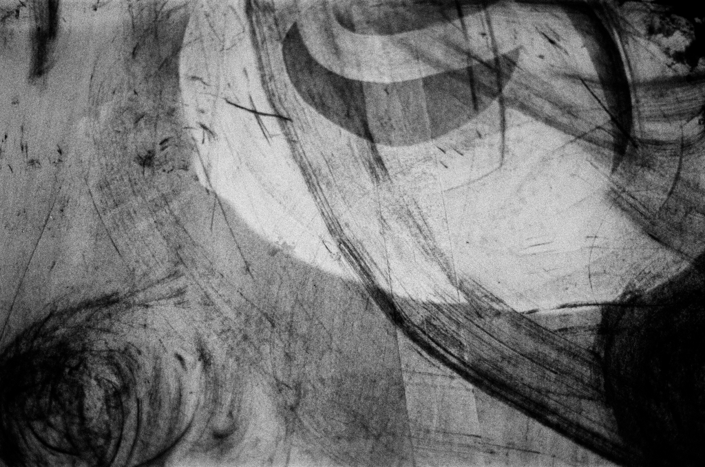 Residuals #1 image 008. Artists Andrew Wood & John Hazel. Charcoal on paper. Created 16 January 2024 at Old Fire Station dance studio, Oxford. UK. Photo: Andrew Wood. Black & whtie 35mm film photograph.