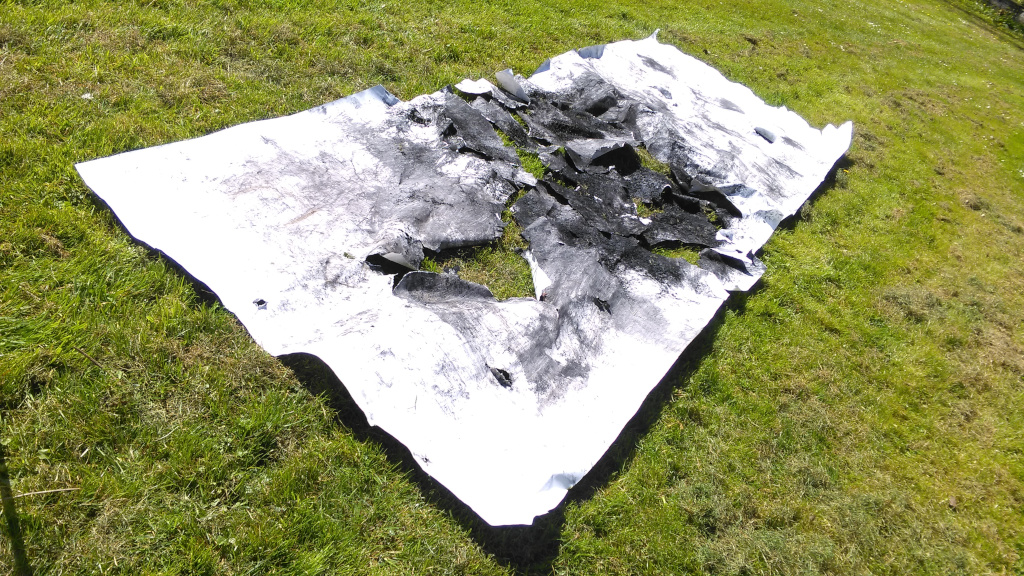 Residuals 3, Dartington Hall Gardens on Saturday 20 April 2024. The charcoal drawing after the performance. The paper was broken and divided by the performers. The parts were reassembled in situ afterwards.